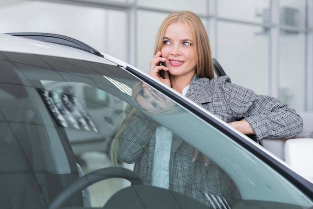 Free photo front view of woman talking on phone