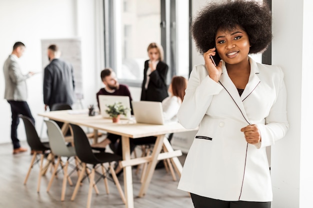 Free photo front view of woman talking at phone