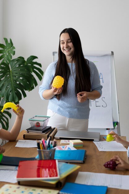 Front view woman teaching kids