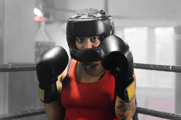 Front view woman training for a boxing competition