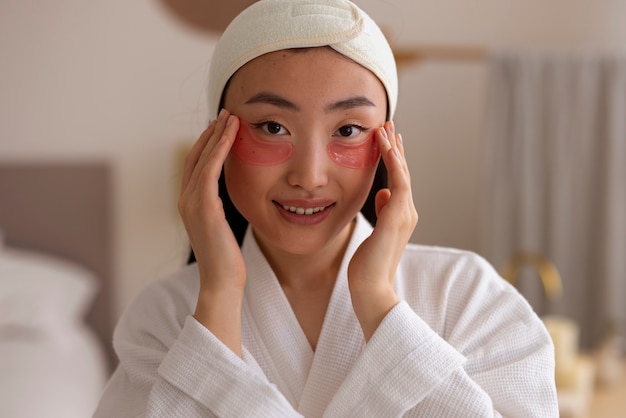 Free Photo front view woman using eye patches