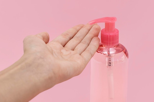 Front view woman using liquid soap