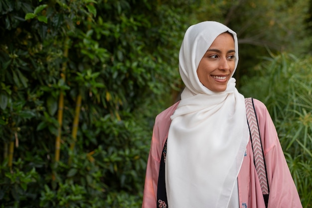 Free photo front view woman wearing halal outdoors