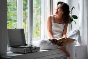 Free photo front view woman wearing linen clothing at home