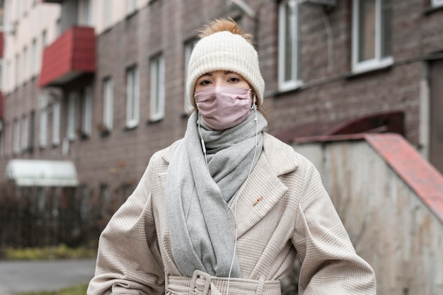 Front view of woman wearing medical mask in the city