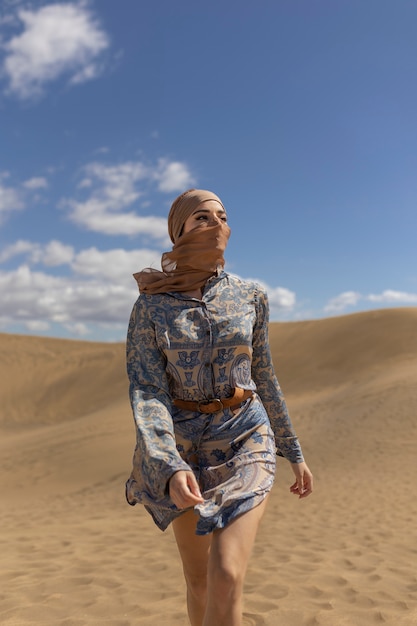 Front view woman wearing scarf in desert