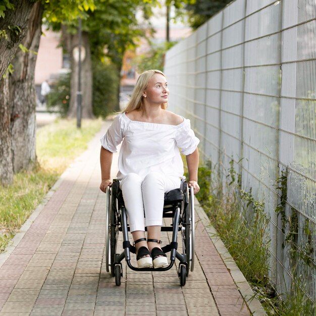 Front view of woman in wheelchair outdoors