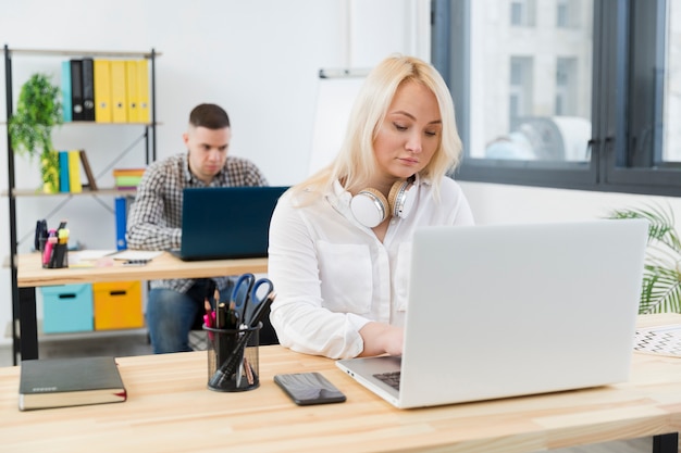 Front view of woman in wheelchair working from her desk at the office