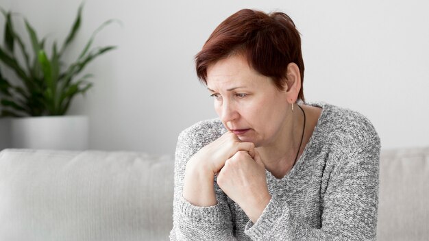 Front view of woman with anxiety on couch