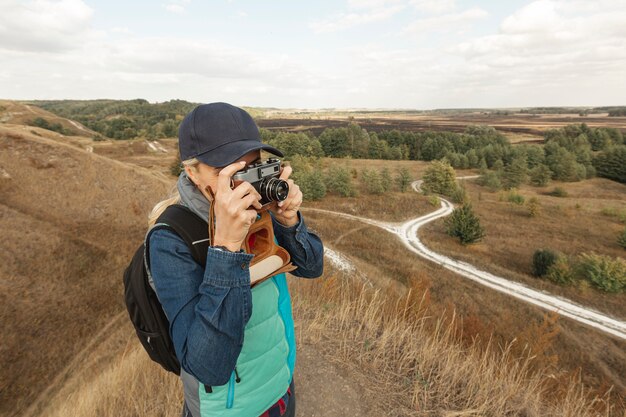 Free photo front view woman with camera outdoor