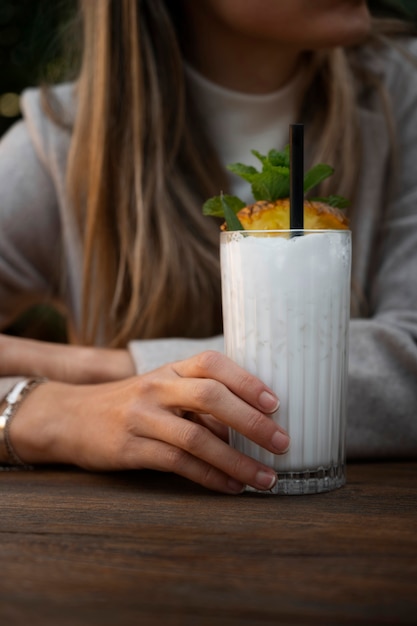 Front view woman with delicious pina colada