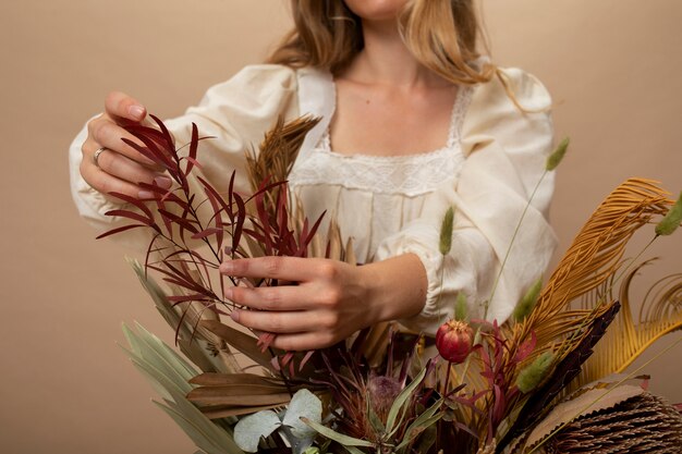 Front view woman with dried plants