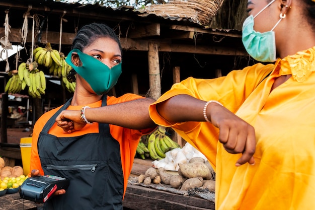 Front view of woman with face mask in market