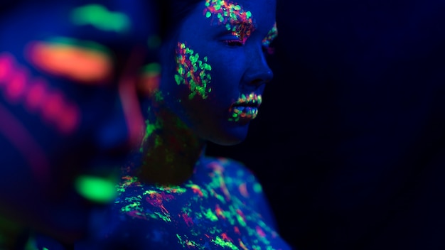 Free photo front view of woman with fluorescent make-up