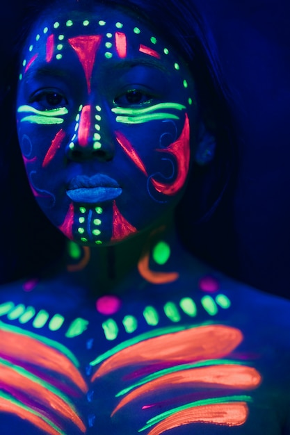 Free photo front view of woman with fluorescent make-up