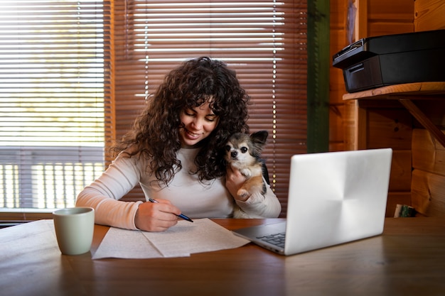 Front view woman with laptop at home