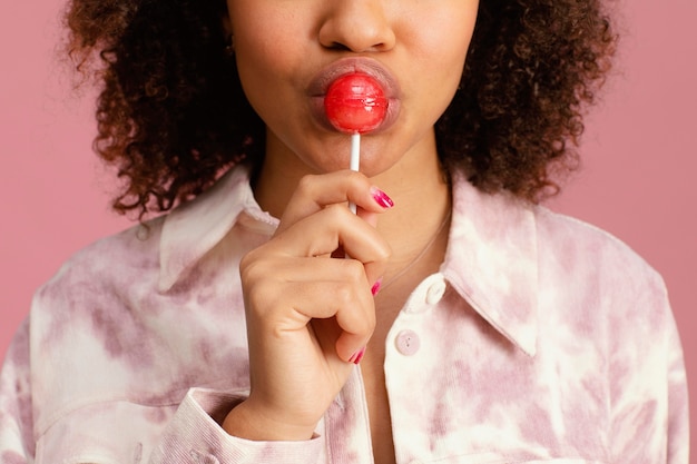 Front view of woman with lollipop