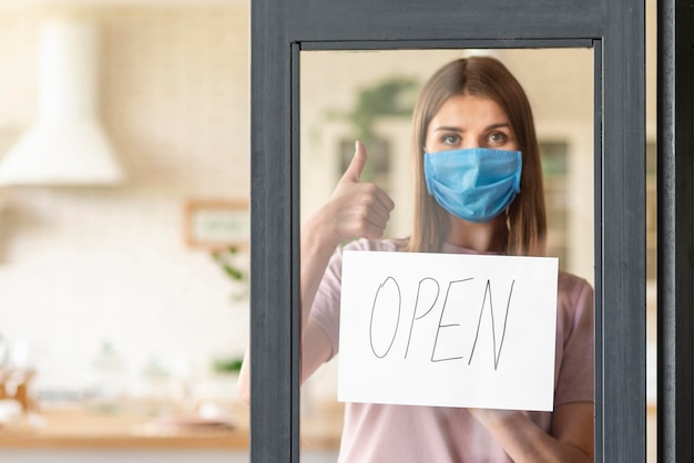 Free photo front view of woman with open sign