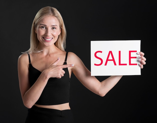 Front view of woman with sale placard