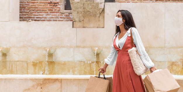 Free Photo front view of woman with shopping bags concept