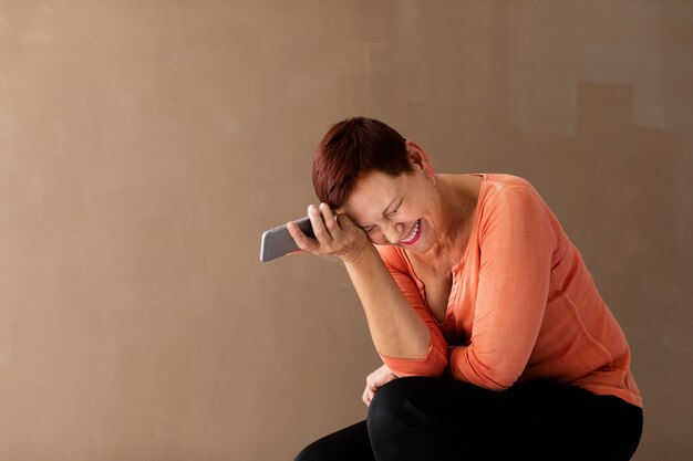 Front view woman with short hair and phone