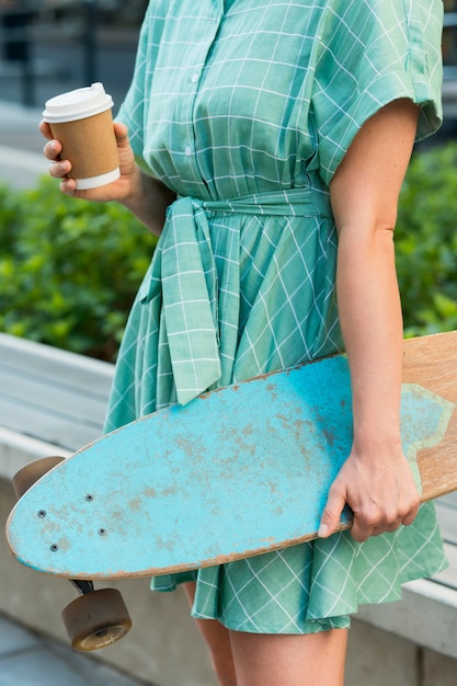 Free photo front view of woman with skateboard