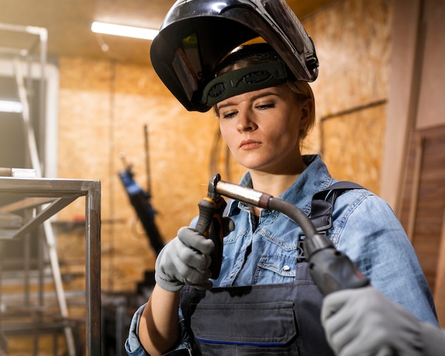 Free photo front view of woman with welding tool