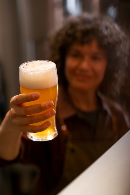 Free photo front view woman working in beer factory