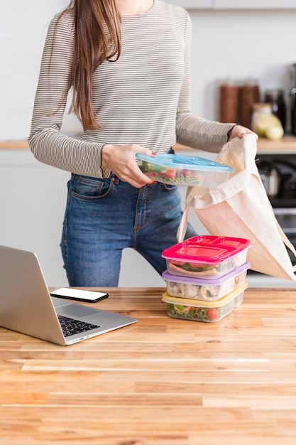 Free photo front view woman working from home and food