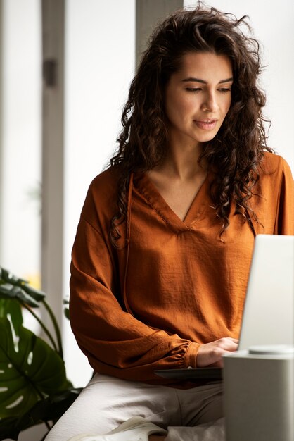 Front view woman working on laptop