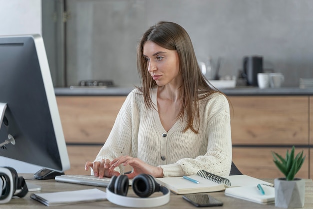 Front view of woman working in the media field with personal computer