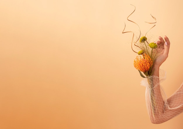 Free photo front view of womans hand with flowers for valentines day