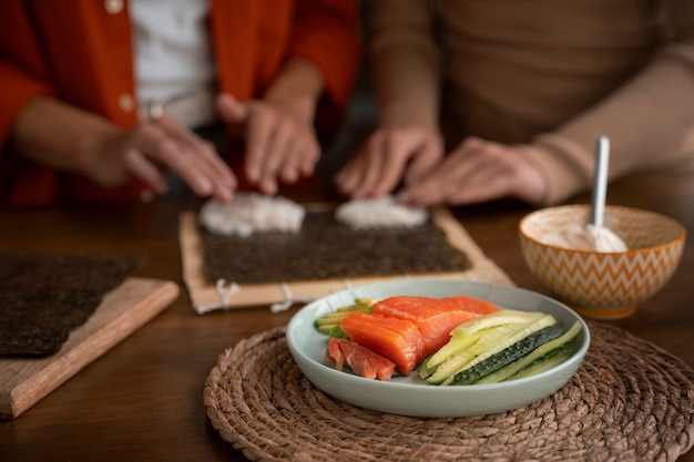 Free Photo front view women learning to make sushi