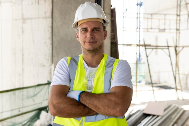 Front view worker in construction wearing protection gear