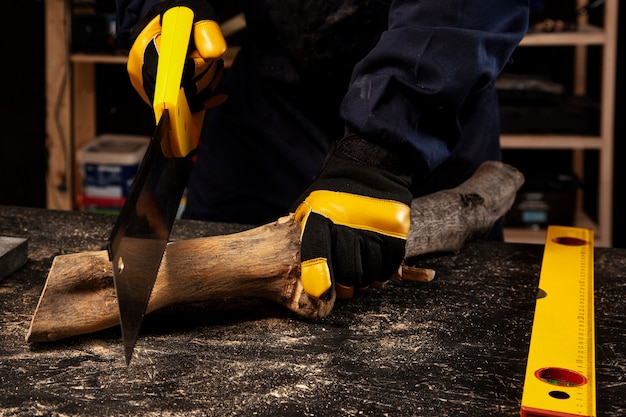 Free Photo front view worker cutting wood