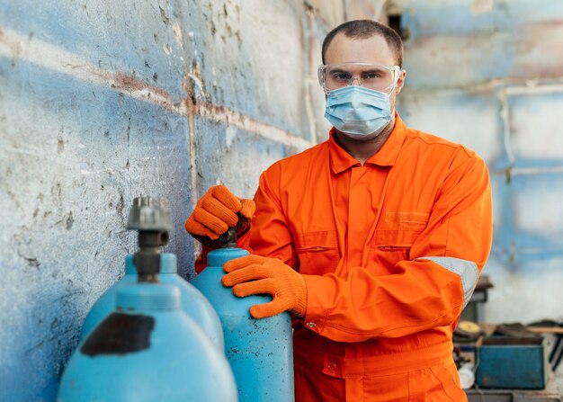 Front view of worker with protective glasses and medical mask