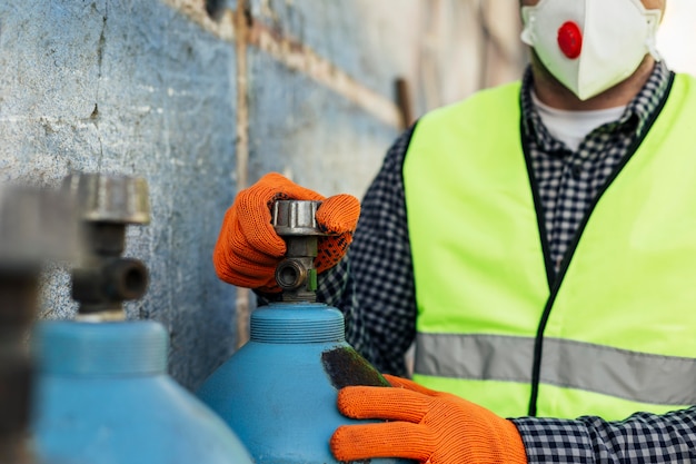 Front view of worker with protective mask and gloves