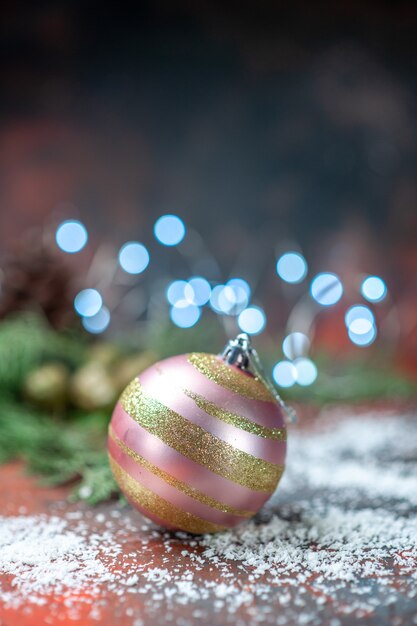 Front view xmas tree ball coconut powder on dark xmas lights