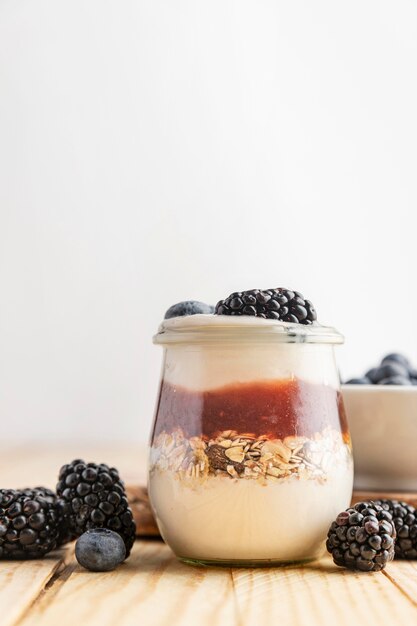 Front view yogurt with berries, jam and oats