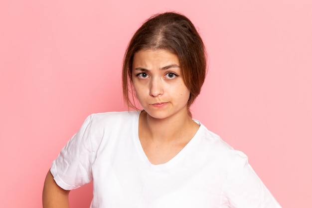 A front view young beautiful female in white shirt posing with thinking expression