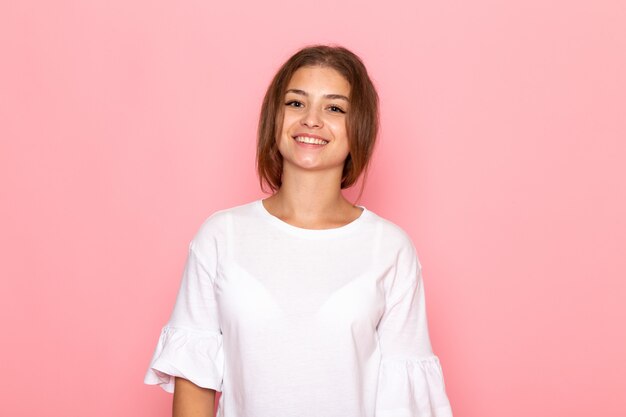 A front view young beautiful female in white shirt posing