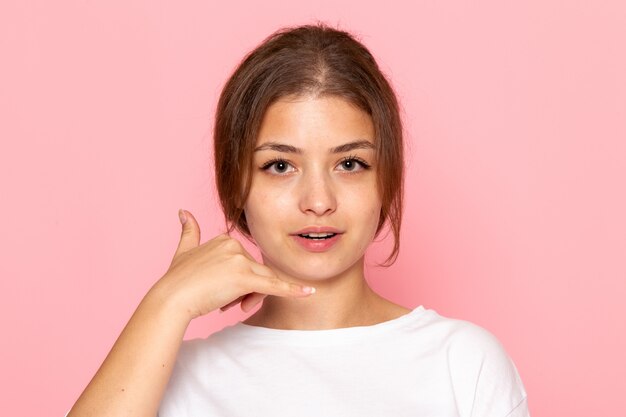 A front view young beautiful female in white shirt posing