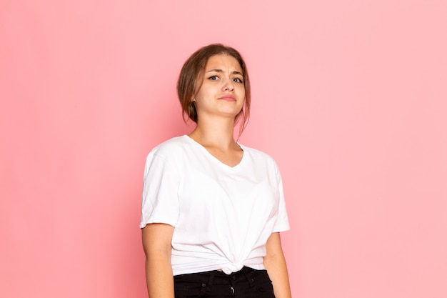 A front view young beautiful female in white shirt with posing with skeptical expression