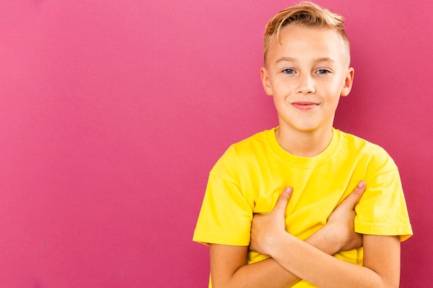 Front view young boy on pink background