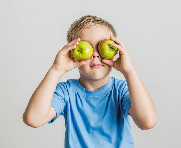 Front view young boy with apples