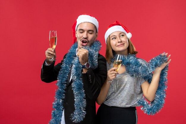 Front view young couple celebrating new year on red floor holiday love christmas