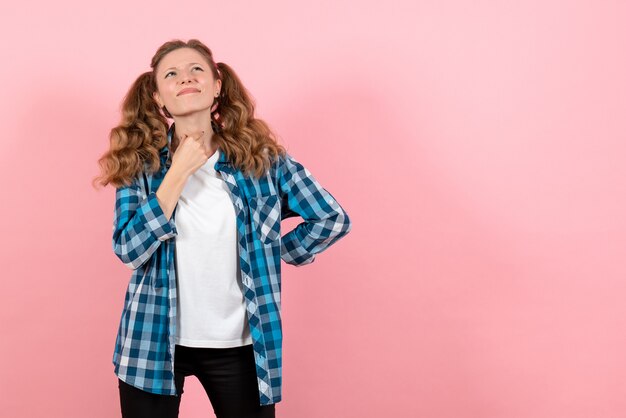 Front view young female in blue checkered shirt posing on pink background girl youth emotion model fashion kid