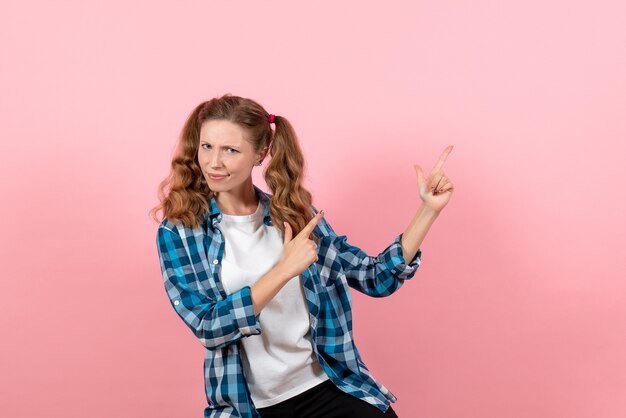 Front view young female in blue checkered shirt posing on a pink background woman emotions girls color model fashion