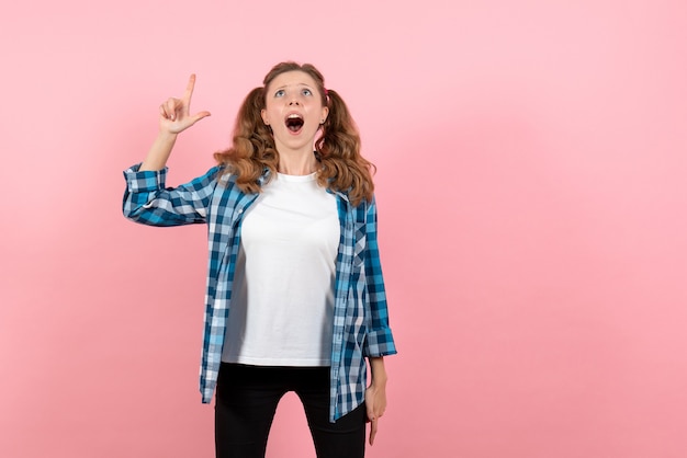 Free photo front view young female in blue checkered shirt posing on pink background woman emotions model fashion girl color