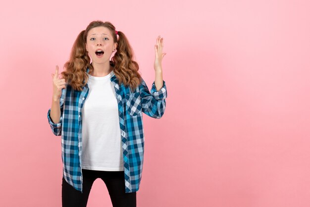 Front view young female in blue checkered shirt posing on pink background youth emotion girl model fashion kid